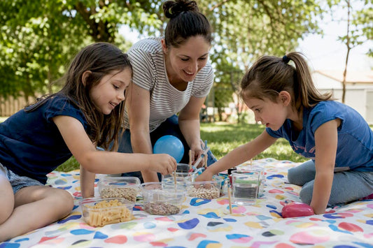 Hands preparing family science night experiment kits