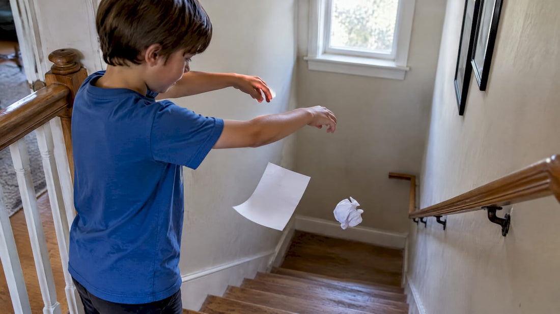Child comparing two falling paper sheets