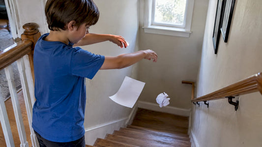 Child comparing two falling paper sheets