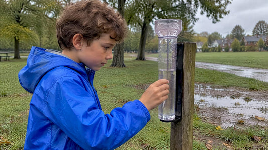 Child checking rain collected in a gauge